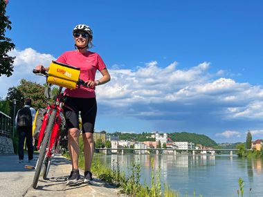 Cyclist on the banks of the Inn in Passau