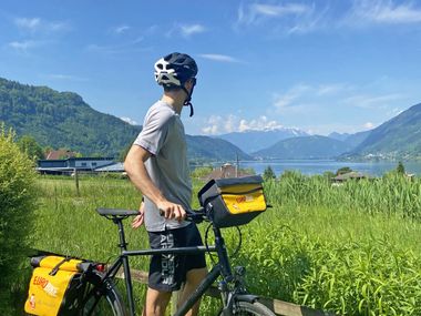 Cyclist views Lake Ossiach in Carinthia