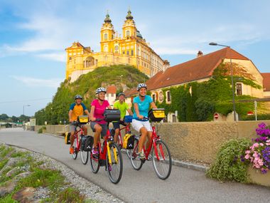 Cyclists with shiny Abbey Melk in the back ground