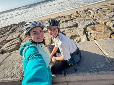 Two cyclists take a selfie on the beach