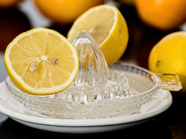 Lemons with lemon squeezer