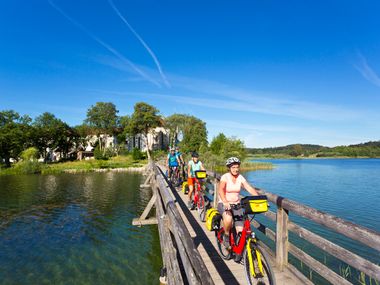 Cyclists on the bridge in front of Seeon Monastery