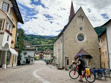 Cyclist looks towards St Andrew's Church in Klausen