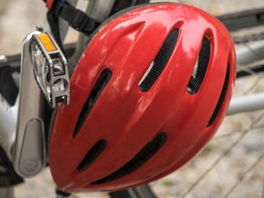 Red bicycle helmet on bike
