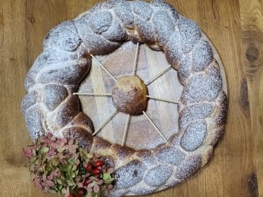 Braided All Saints' Striezel with icing sugar