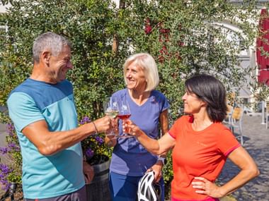 Two women and one man at a wine tasting in the Palatinate region on the German Wine Route