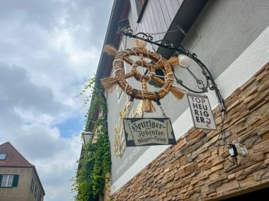 Straw wreath in front of an open wine tavern
