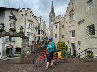 Cyclist on the town square in Brixen