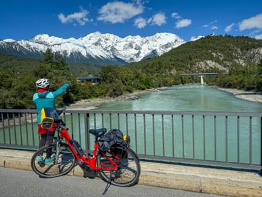Cyclist gazes into the distance from the Inn Bridge