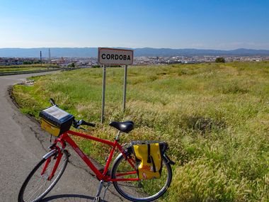 Bicycle in front of a town sign in Cordoba