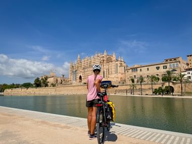 Cyclist in front of the cathedral in Palma