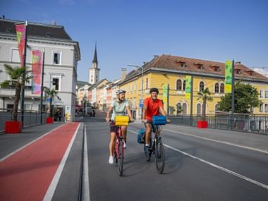 Two cyclist on the city bridge in Villach