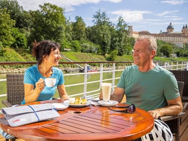 two people have breakfast on the boat