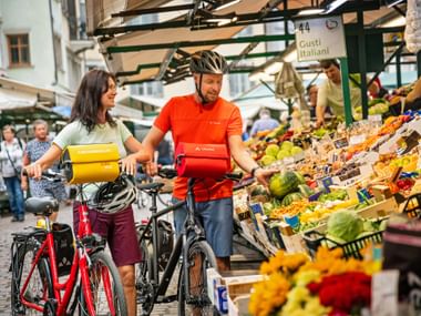 2 cyclist at a market