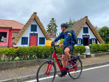 Cyclist in front of Portuguese straw huts