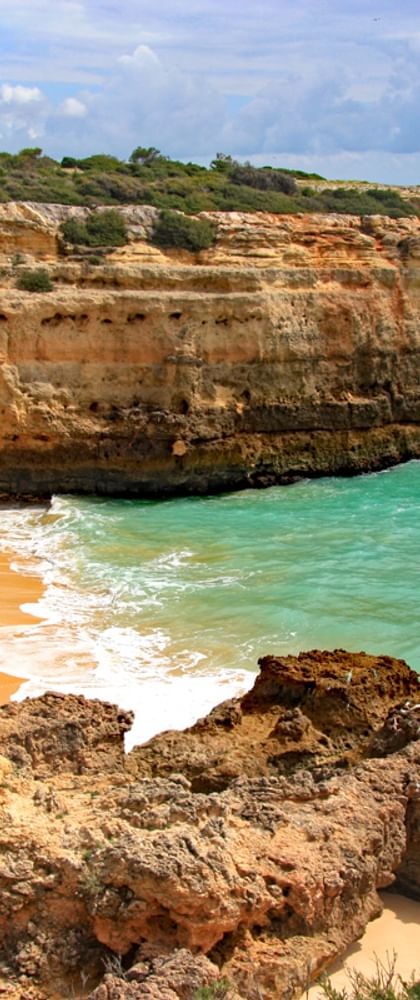 Secluded beach with turquoise-blue water in the rocky Algarve