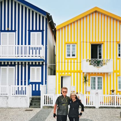 Cyclists in front of Palheiros in Praia da Costa Nova