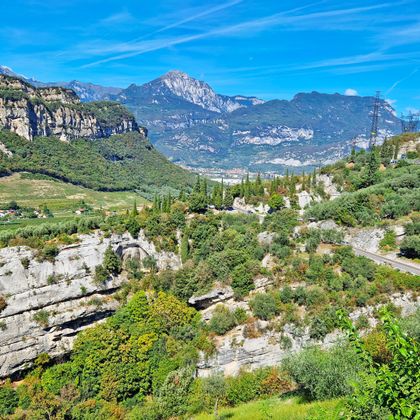 Cycle route above Lake Garda with a view of a rocky landscape and mountains in the background