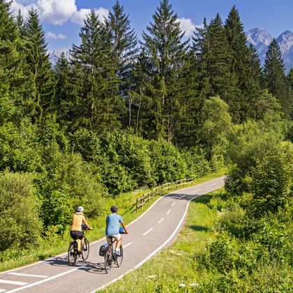 Two cyclists on the Alpe-Adria cycle path in the Canal Valley near Tarvisio