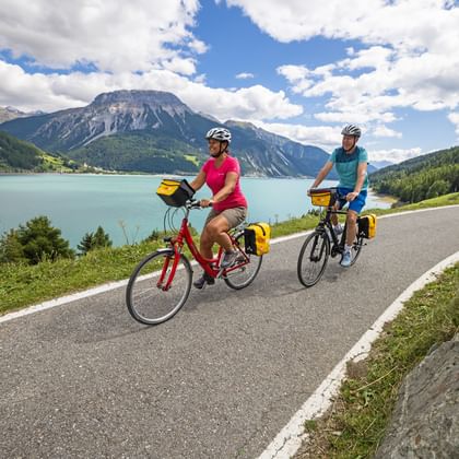 Cyclists ride along the Adige