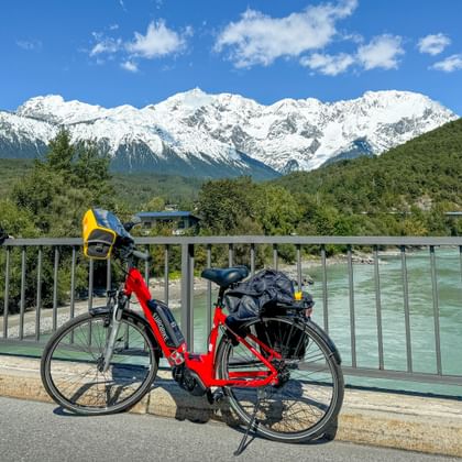 Cyclist on the Inn bridge near Mötz with a view of the western Mitterspitz
