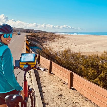 Cyclist on the road with beach and sea in the background