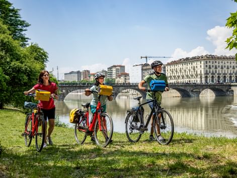 Cyclists on the banks of the Po River in Turin