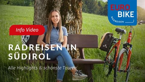 Woman sitting on wooden bench under tree with red bicycle in green meadow. Text reads 'Radreisen in Südtirol' with Eurobike logo.