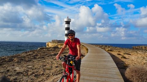 Cyclists at the lighthouse of Colònia de Sant Jordi
