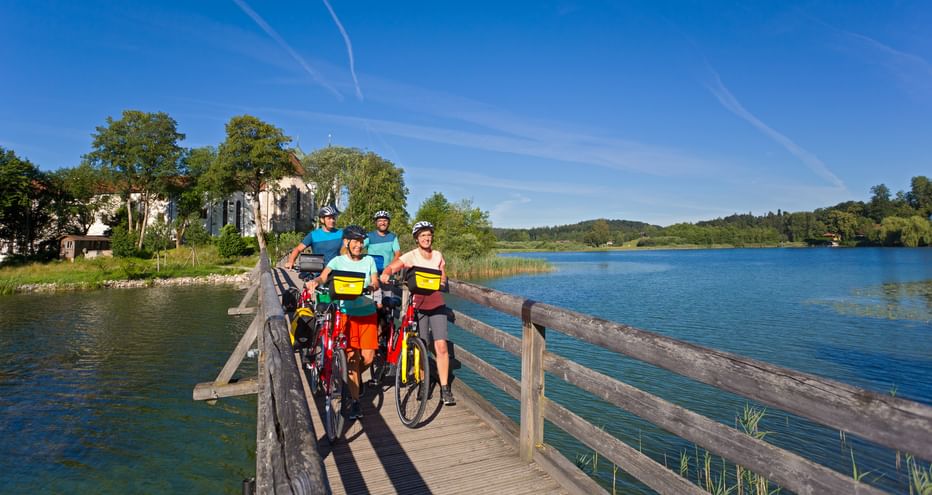 Cyclists on the bridge to Seeon Monastery
