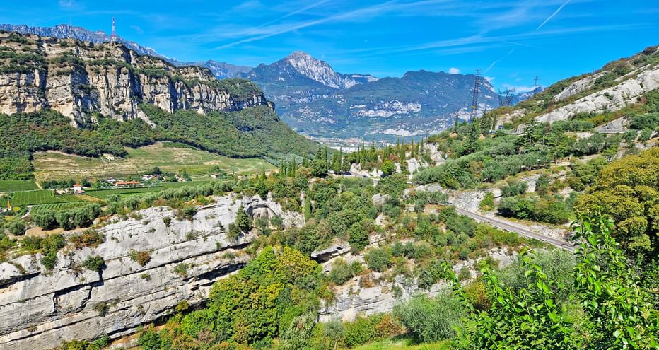 Cycle route above Lake Garda with a view of a rocky landscape and mountains in the background