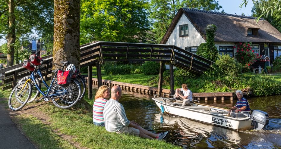 Cycle break by the canal with passing boat