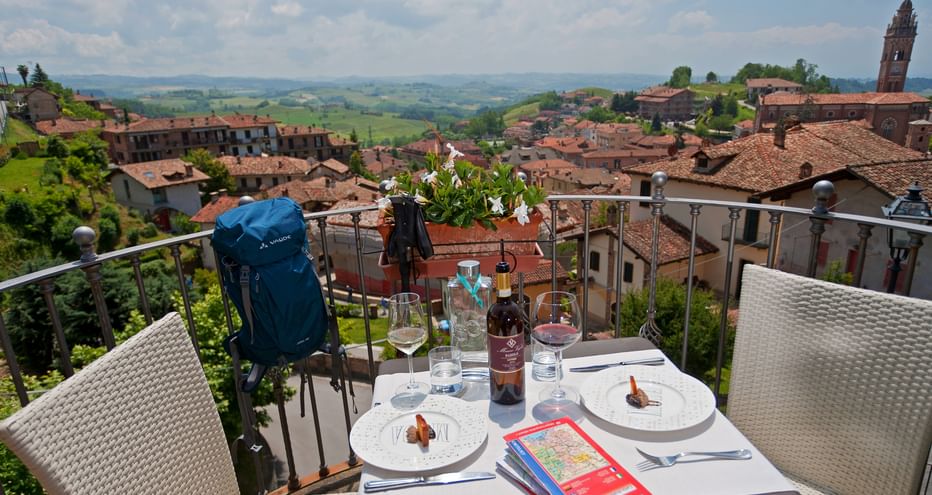 View from a restaurant terrace of the old town of Monforte d'Alba with rolling hills in the background