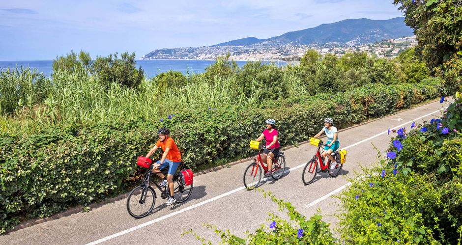 Three cyclists on coastal cycle path in Sanremo
