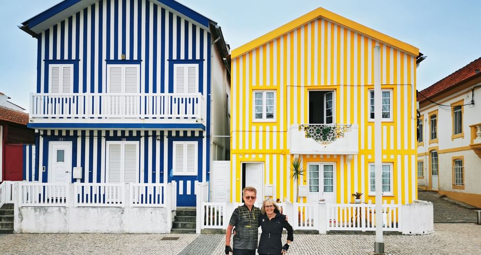 Cyclists in front of Palheiros in Praia da Costa Nova