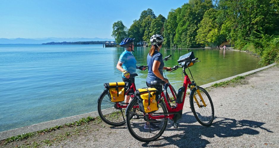 Two cyclists during a bike stop on the shore of Lake Starnberg