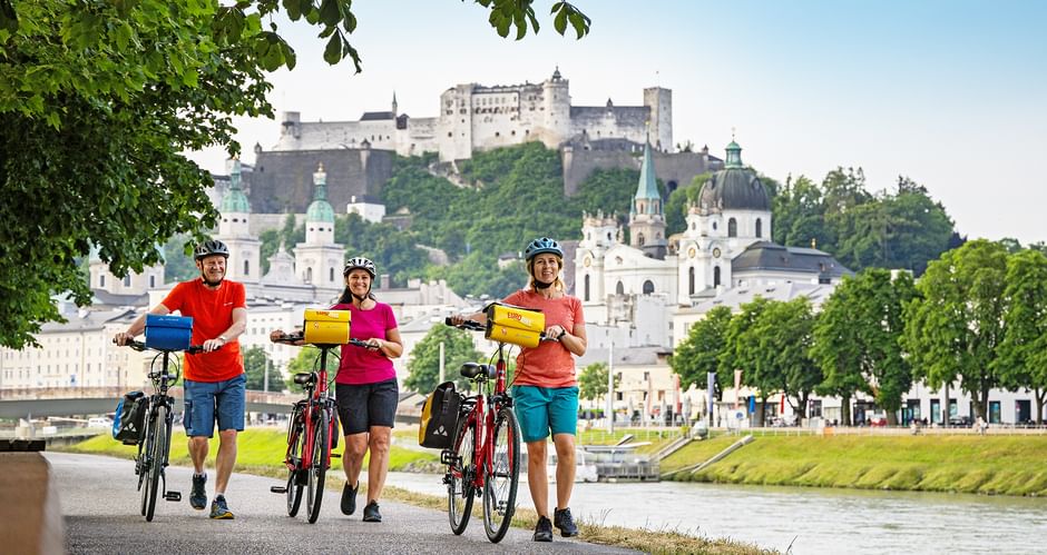 Cyclists next to the Salzach in Salzburg
